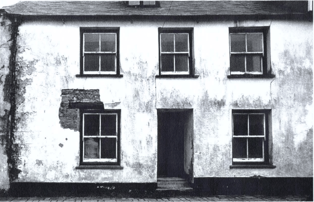 20 Lower Bore Street A large house with a damaged, cracked exterior and several windows.